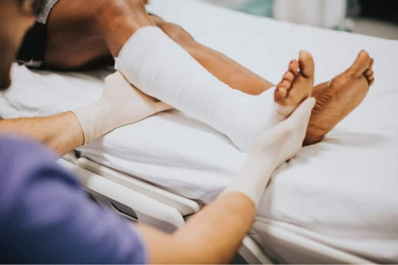 personal treating someone's leg after truck accident
